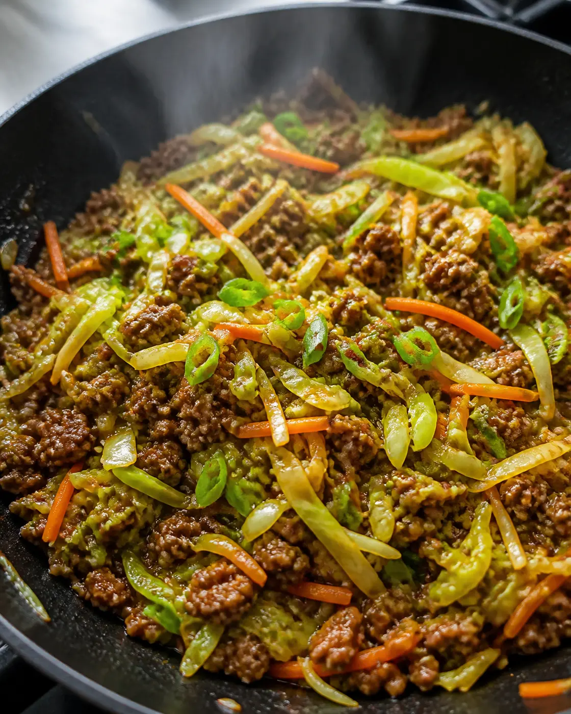 Ground beef and cabbage stir-fry with carrots, scallions, and garlic ginger sauce