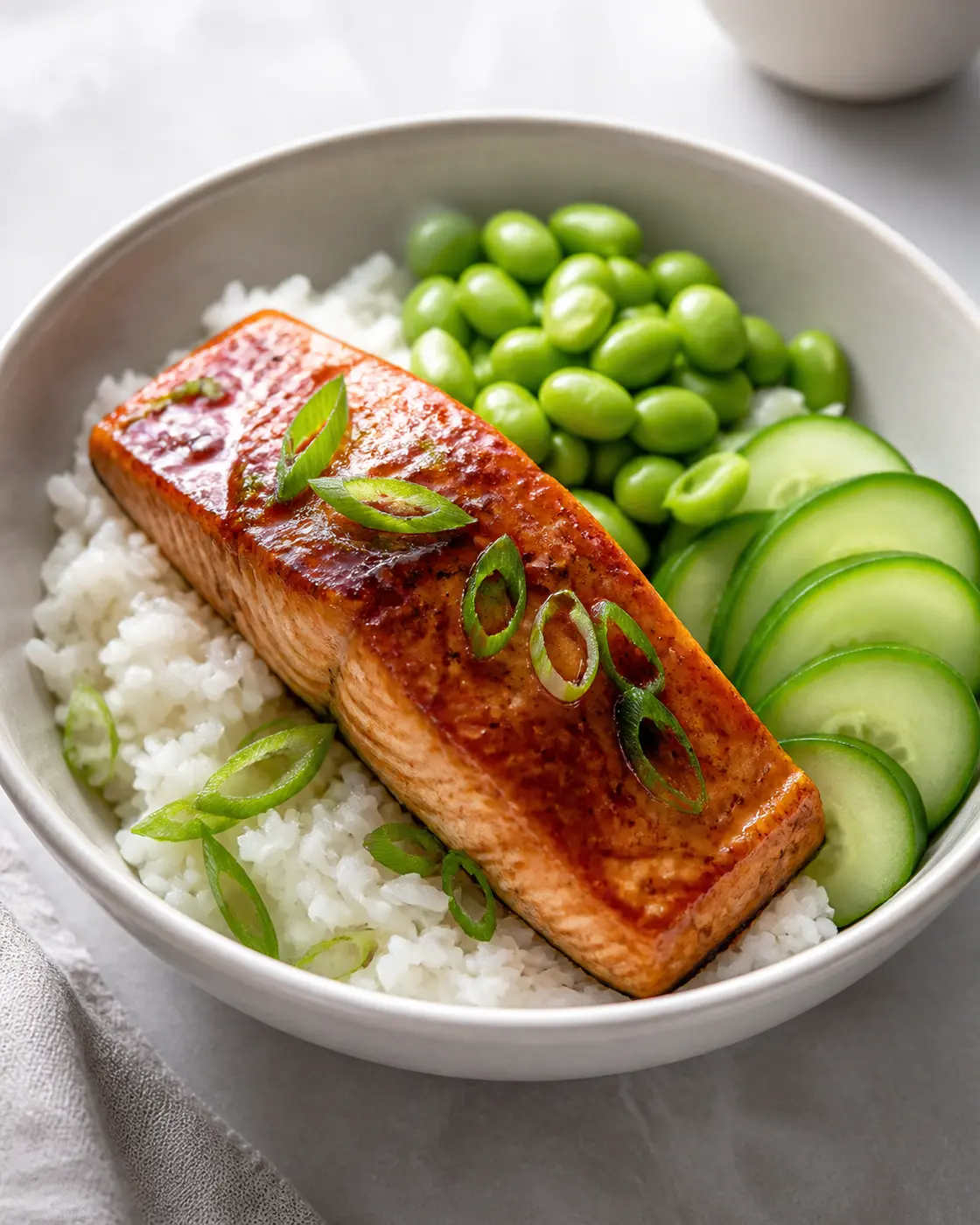 Honey garlic salmon rice bowls with edamame, cucumber, and scallions