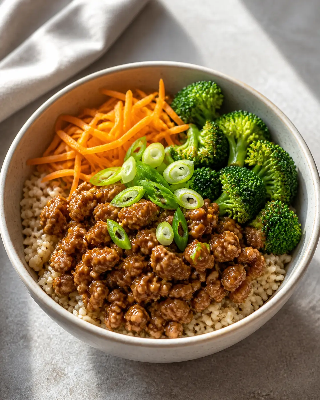 Teriyaki ground turkey rice bowls with broccoli, carrots, and scallions